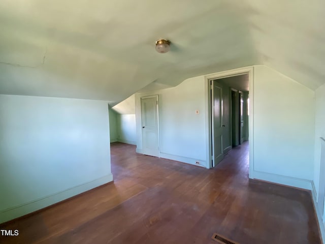 bonus room with vaulted ceiling, baseboards, and wood finished floors