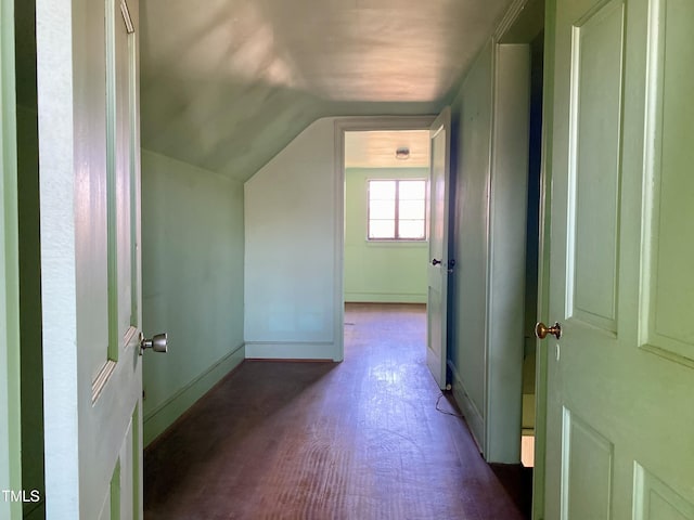 bonus room with baseboards, lofted ceiling, and wood finished floors