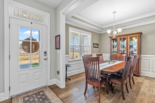 238 Ashpole Trl, Clayton, NC 27520 - dining room with a chandelier, light wood-style flooring, wainscoting, ornamental molding, and a decorative wall