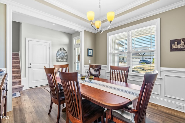 238 Ashpole Trl, Clayton, NC 27520 - dining room featuring wood finished floors, wainscoting, stairs, crown molding, and a chandelier
