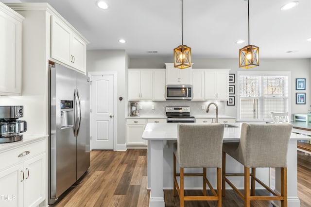 238 Ashpole Trl, Clayton, NC 27520 - kitchen featuring stainless steel appliances, light countertops, backsplash, recessed lighting, and wood finished floors