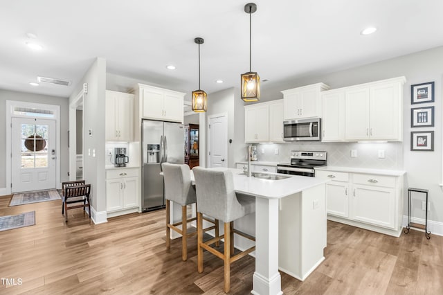 238 Ashpole Trl, Clayton, NC 27520 - kitchen with appliances with stainless steel finishes, light countertops, tasteful backsplash, recessed lighting, and a kitchen bar