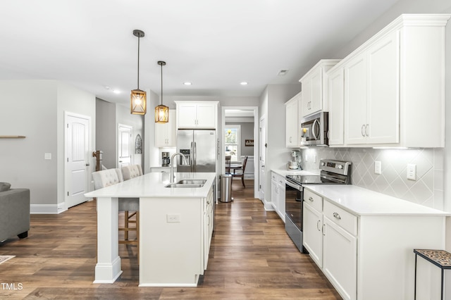 238 Ashpole Trl, Clayton, NC 27520 - kitchen with stainless steel appliances, recessed lighting, tasteful backsplash, dark wood finished floors, and a kitchen breakfast bar