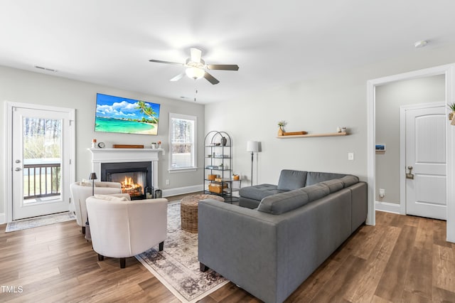 238 Ashpole Trl, Clayton, NC 27520 - living area featuring a glass covered fireplace, ceiling fan, and wood finished floors