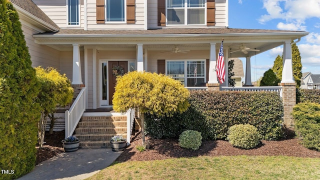 property entrance with ceiling fan and a shingled roof