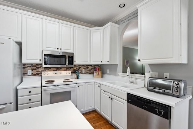 kitchen featuring appliances with stainless steel finishes, white cabinetry, and a sink