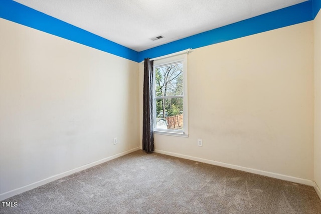 unfurnished room featuring visible vents, baseboards, a textured ceiling, and carpet flooring