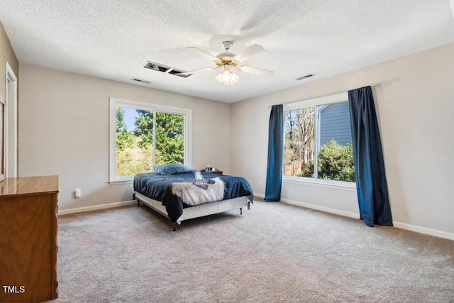 carpeted bedroom featuring visible vents, multiple windows, and baseboards