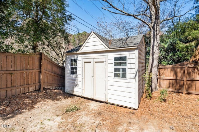 view of shed with a fenced backyard