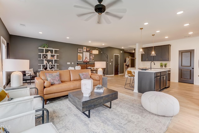 living area featuring light wood finished floors, visible vents, recessed lighting, and ceiling fan