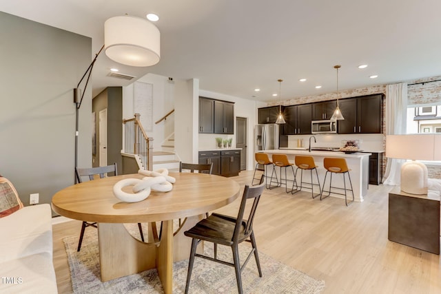 dining room featuring stairs, recessed lighting, visible vents, and light wood finished floors