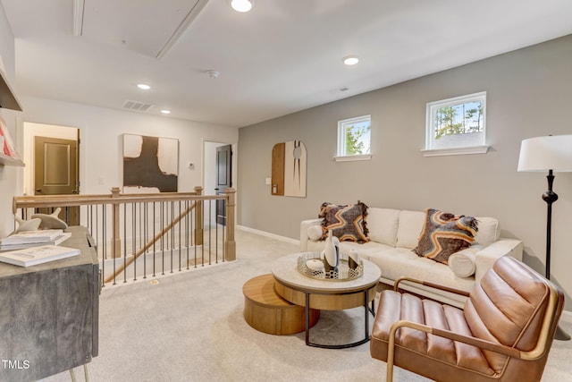 carpeted living area with attic access, recessed lighting, visible vents, and baseboards