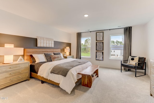 bedroom featuring light carpet and baseboards