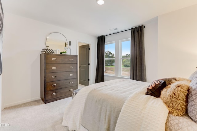 bedroom with visible vents, baseboards, and light colored carpet