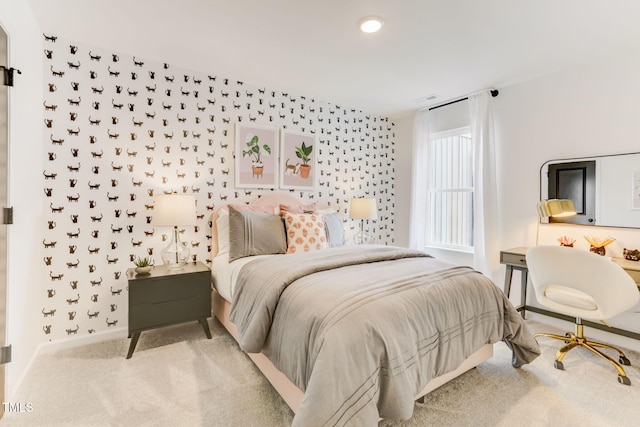 bedroom featuring visible vents, baseboards, and carpet