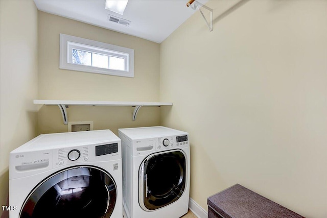 laundry room featuring laundry area, washing machine and dryer, and visible vents