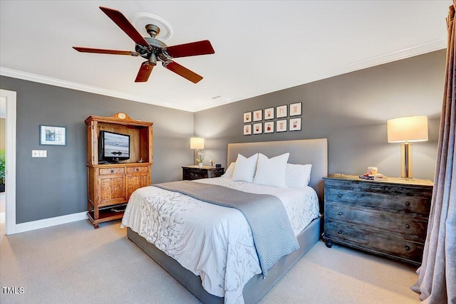 carpeted bedroom with a ceiling fan, baseboards, and ornamental molding