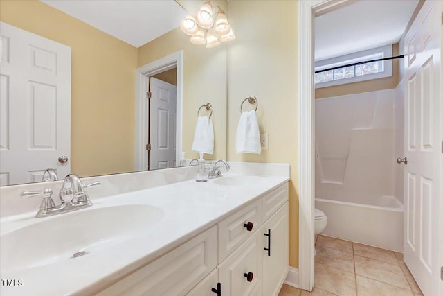 full bathroom with a sink, toilet, double vanity, and tile patterned floors