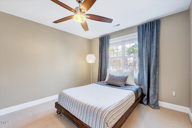 bedroom with visible vents, baseboards, and light colored carpet