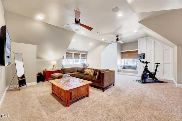 living area featuring light carpet, visible vents, a healthy amount of sunlight, and lofted ceiling