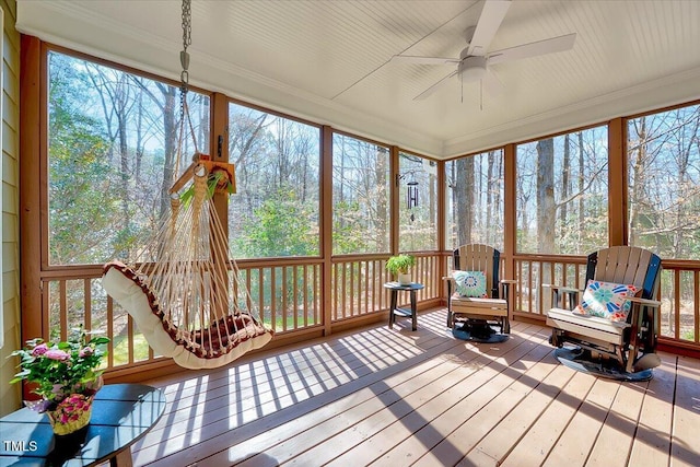 sunroom featuring a healthy amount of sunlight and a ceiling fan