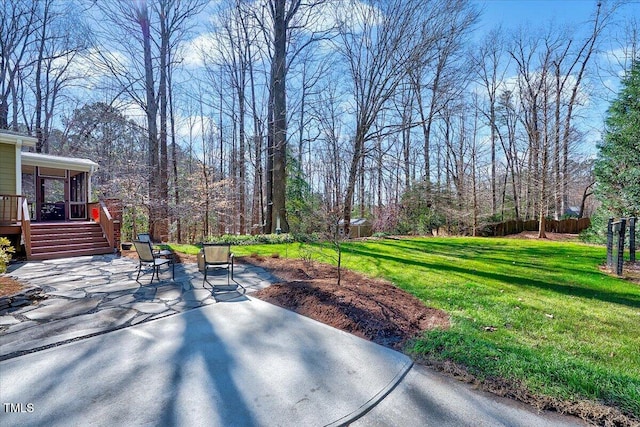 view of patio featuring stairway and fence