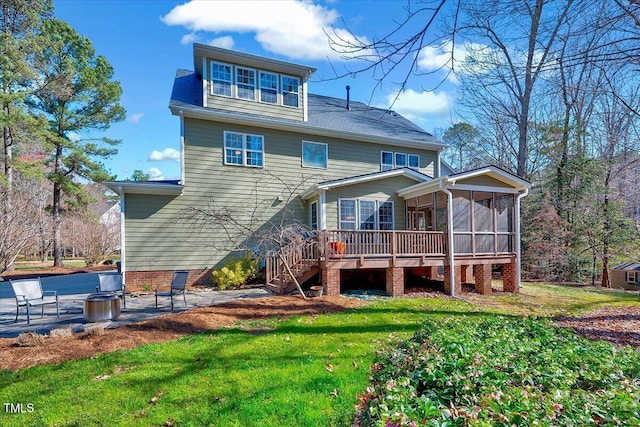 back of house with a patio area, a lawn, stairs, and a sunroom