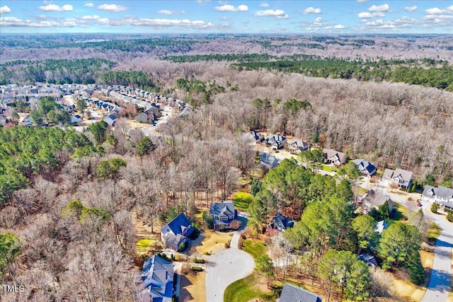 birds eye view of property featuring a forest view and a residential view