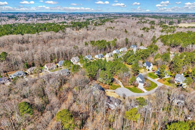 drone / aerial view with a wooded view