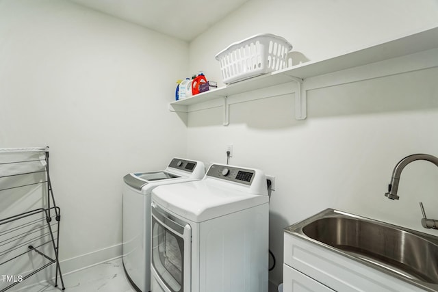 clothes washing area with marble finish floor, independent washer and dryer, baseboards, and a sink