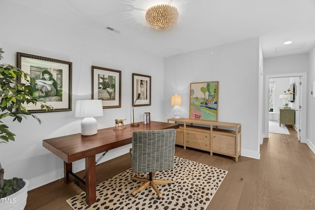 home office with recessed lighting, visible vents, baseboards, and wood finished floors