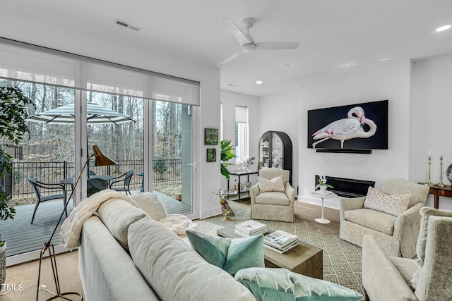 living area featuring visible vents, recessed lighting, ceiling fan, and wood finished floors