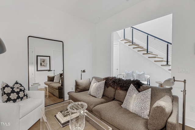 living area with wood finished floors and stairs