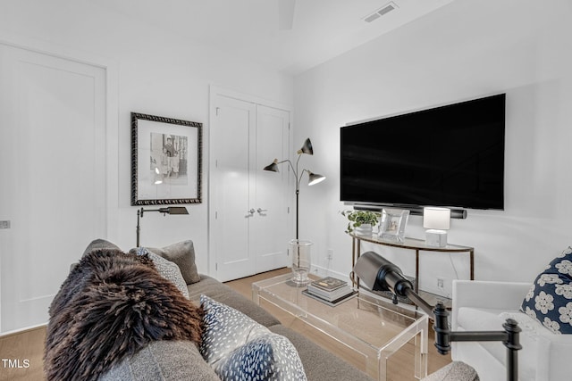 living room with wood finished floors and visible vents