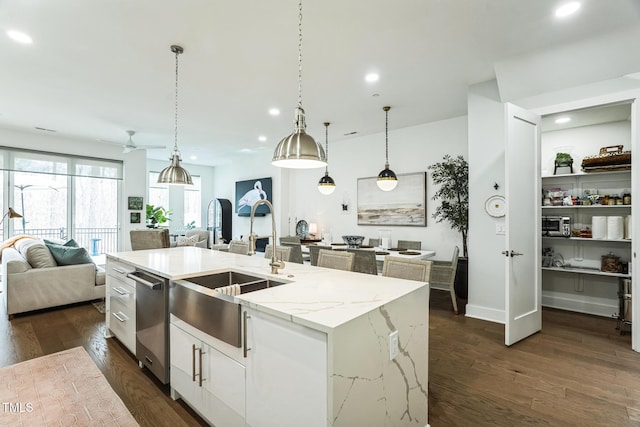 kitchen featuring a kitchen island with sink, dark wood-style floors, dishwasher, and open floor plan