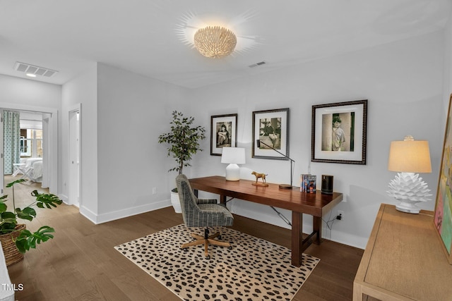 office space with visible vents, baseboards, and wood finished floors