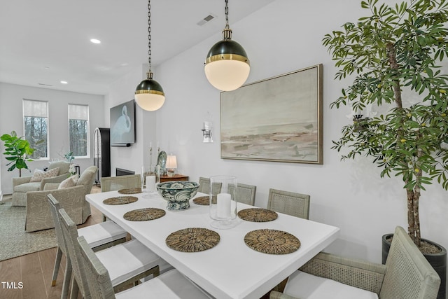 dining space with recessed lighting, visible vents, and wood finished floors