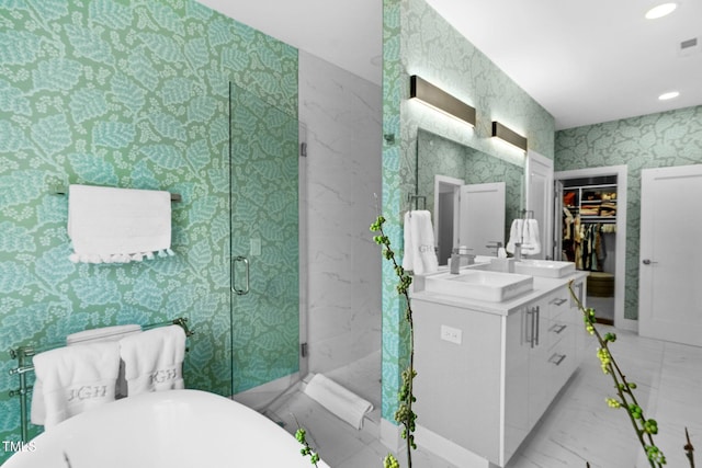 bathroom featuring vanity, a marble finish shower, wallpapered walls, a soaking tub, and marble finish floor