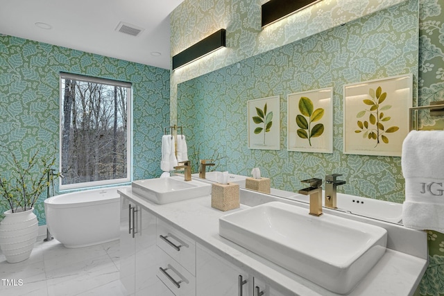 bathroom featuring a sink, visible vents, and wallpapered walls