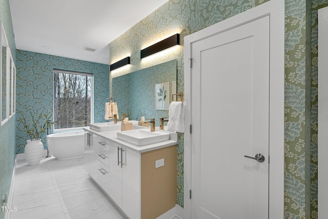 bathroom featuring visible vents, marble finish floor, wallpapered walls, and a sink