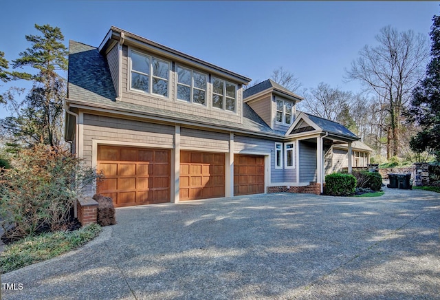 805 Greenwood Rd, Chapel Hill, NC 27514 - view of front facade with an attached garage, driveway, and roof with shingles