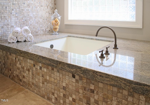 805 Greenwood Rd, Chapel Hill, NC 27514 - room details featuring tasteful backsplash, white cabinetry, a sink, and light stone counters