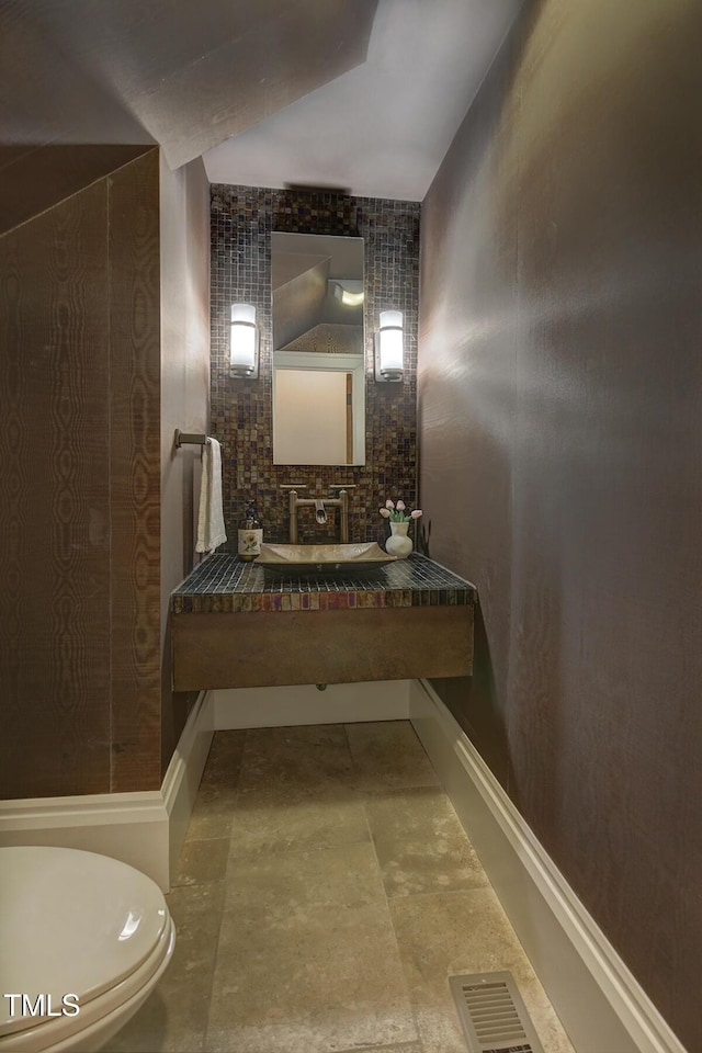 805 Greenwood Rd, Chapel Hill, NC 27514 - bathroom featuring toilet, a sink, lofted ceiling, and visible vents
