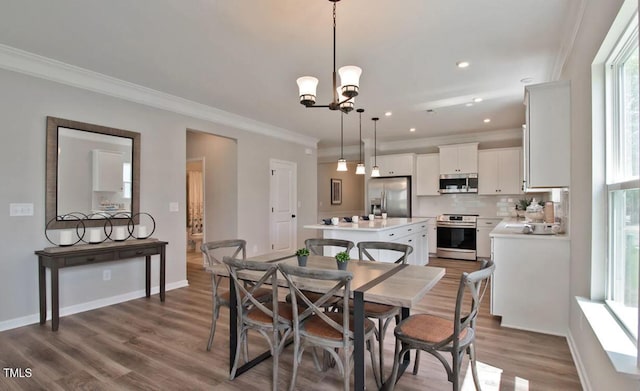 dining room featuring an inviting chandelier, crown molding, dark wood-style floors, and baseboards