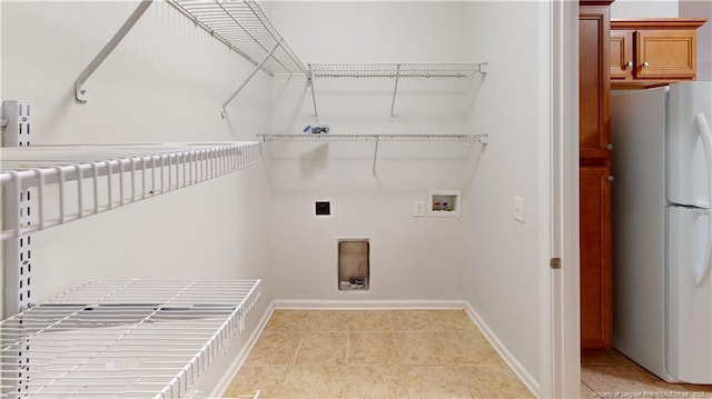 laundry area with hookup for a washing machine, light tile patterned floors, baseboards, hookup for an electric dryer, and laundry area