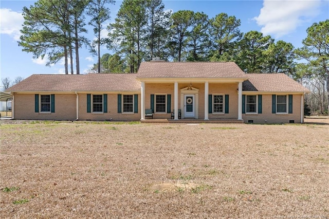 single story home with crawl space, covered porch, brick siding, and a front yard