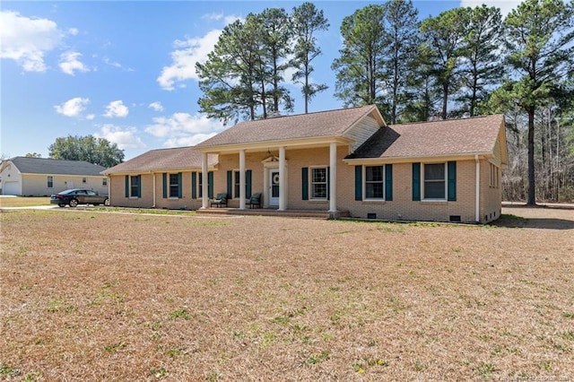 view of front of home featuring crawl space, brick siding, a porch, and a front yard