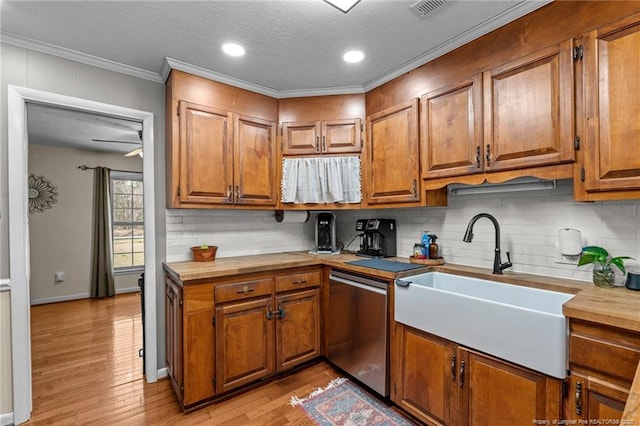 kitchen featuring a sink, stainless steel dishwasher, brown cabinetry, and light wood finished floors