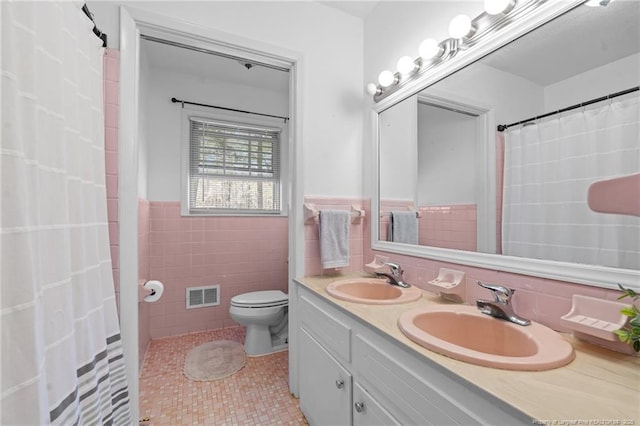 full bathroom with tile patterned floors, toilet, visible vents, and a sink