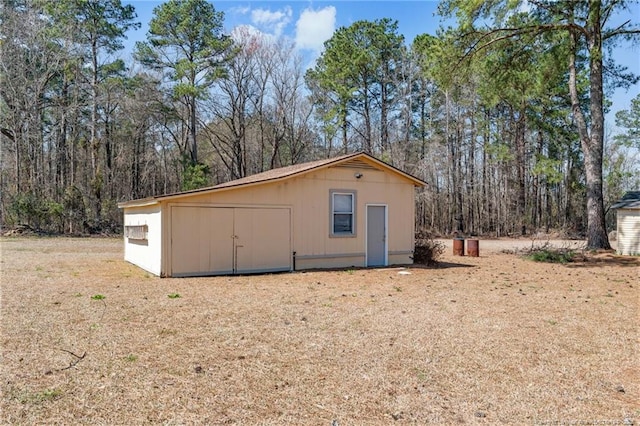 view of shed with a forest view